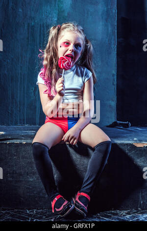 The funny crasy girl with candy on dark background Stock Photo