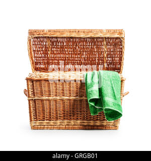 Open wicker clothes box. Laundry basket with green towel. Treasure chest. Object isolated on white background with clipping path Stock Photo