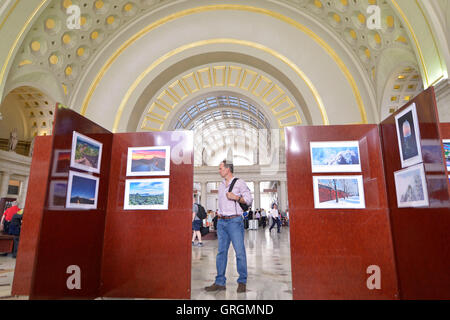 Washington, DC, USA. 6th Sep, 2016. Visitors view pictures at Charming Beijing Photo Exhibition at the main hall of the Union Station of Washington, DC, the United States, Sept. 6, 2016. The exhibition called Charming Beijing, which will last for four days, was held by the Beijing municipal government to celebrate 'China-U.S. Tourism Year' and to introduce Beijing's tourist attractions to local people. © Yin Bogu/Xinhua/Alamy Live News Stock Photo