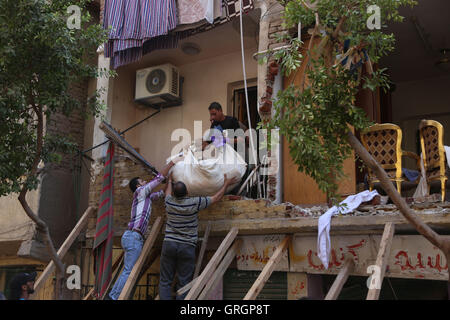 Cairo. 7th Sep, 2016. People take belongings out of the ruins of a collapsed house at Al-Zawya neighborhood in Cairo, Egypt on Sept. 7, 2016. Part of the building collapsed due to a gas bomb, killing one person and injuring seven. Credit:  Ahmed Gomaa/Xinhua/Alamy Live News Stock Photo