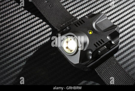 Tactical flashlight worn on the wrist that is on Stock Photo