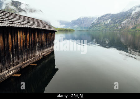 Cottage in the lake of Hallstatt a foggy and rainy day Stock Photo