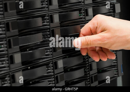 IT consultant replaces SAN harddrive in datacenter Stock Photo