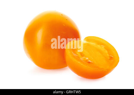 Yellow tomatoe with half slice on white Stock Photo