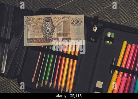 expensive school theme, pencil case with Polish money Stock Photo