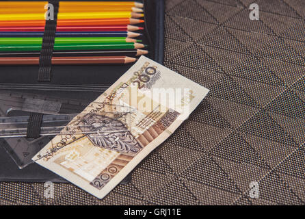 expensive school theme, pencil case with Polish money Stock Photo