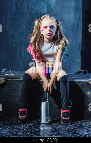 Horror shot: a scary evil girl with bloody knife Stock Photo