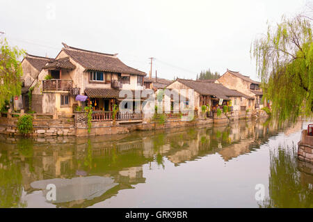 The buildings and water canals of Fengjing Town in Shanghai China on an overcast day. The Chinese character cha or tea Stock Photo