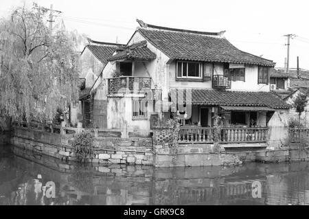 A black and white image of  buildings and water canals of Fengjing Town in Shanghai China on an overcast day. Stock Photo