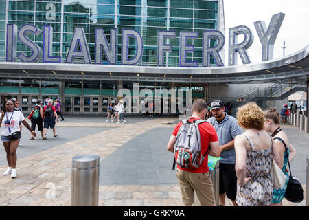 New York City,NY NYC Lower Manhattan,Financial District,Whitehall Ferry Terminal,Staten Island Ferry,exterior,sign,hawker,pitchman,adult,adults,man me Stock Photo