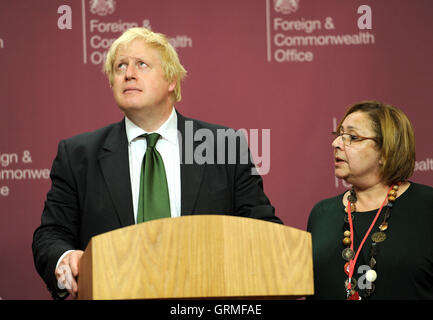 Foreign Secretary Boris Johnson, looks at the ceiling as he listens to former Prime Minister Dr Riyad Farid Hijab, the leader of the High Negotiations Committee of the Syrian Opposition (HNC) talking during a press briefing following a meeting with representatives of the Syrian opposition and foreign ministers from across the world, at the Foreign and Commonwealth Office in central London. Stock Photo