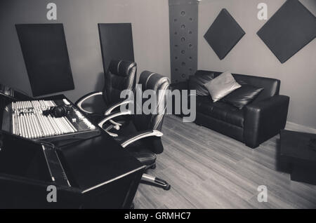 Classy professional recording studio setup, large desk with mixing ...