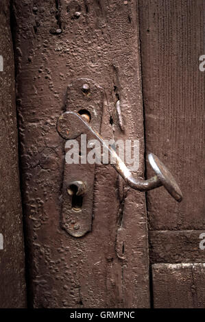 Close up image of old wooden door with metal knob. Stock Photo