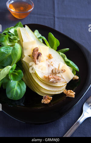 Pear salad with parmesan cheese and walnuts Stock Photo