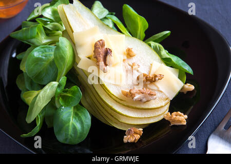 Pear salad with parmesan cheese and walnuts Stock Photo