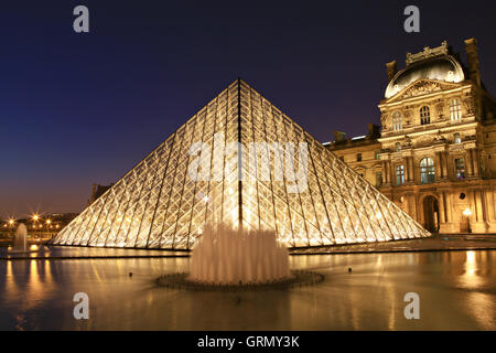 Paris, France - March 20,2013: Louvre museum at dusk on March 20, 2013 in Paris Stock Photo