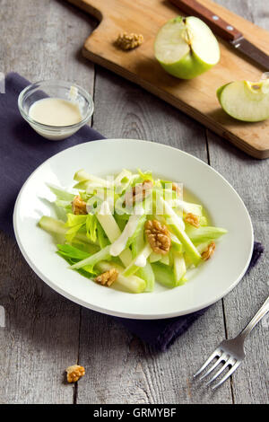 Waldorf salad with green apple, celery and walnuts over rustic wooden background Stock Photo