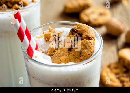 Homemade milkshake with chocolate chips cookies and nuts  on rustic wooden table close up Stock Photo
