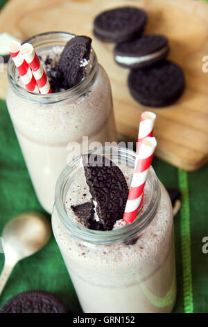 Homemade milkshake (chocolate smoothie) with cookies on linen napkin close up Stock Photo