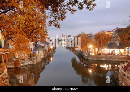 The buildings and water canals of Fengjing Town in Shanghai China at dusk with autumn colors. Stock Photo