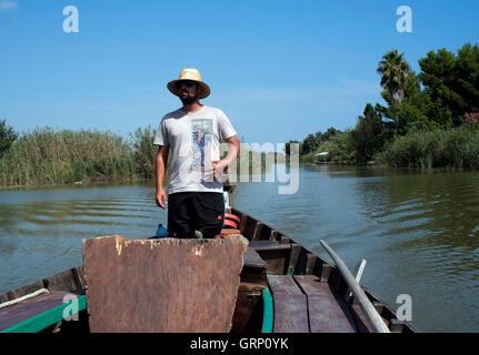 A boatman guides a boat on the Albufera Natural Park lake,  in Spain September 1, 2016. Copyright photograph John Voos Stock Photo