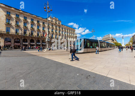 BORDEAUX, FRANCE - APRIL 4, 2011: Modern tram crossing Grand Theatre square in front of Regent hotel Stock Photo