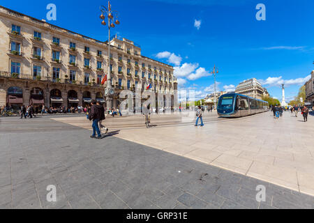 BORDEAUX, FRANCE - APRIL 4, 2011: Modern tram crossing Grand Theatre square in front of Regent hotel Stock Photo