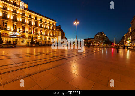 BORDEAUX, FRANCE - APRIL 4, 2011: French people walking in front of Regent hotel on Grand Theatre square at night Stock Photo