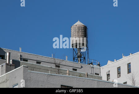 An old wooden water tank on the roof of a building in New York City. Stock Photo