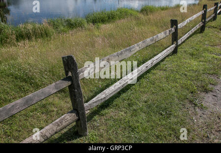 Sections of an old weathered wooden split rail fence. Stock Photo