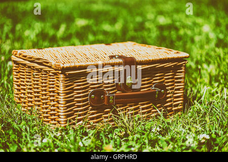 Picnic Basket Hamper With Leather Handle In Green Grass Stock Photo