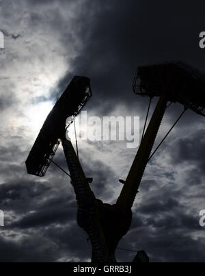 Two sets of swing are nearly at apex in a carnival ride. Stock Photo