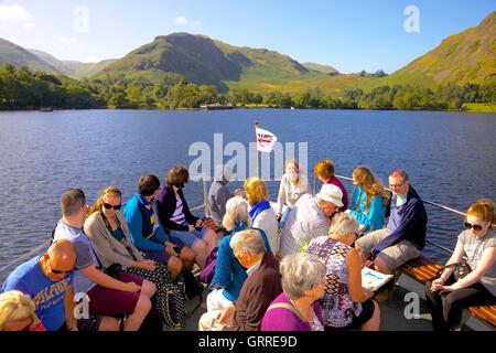 Tourists enjoying a cruise aboard the bow of Ullswater Steamers M.V Lady Wakefield. Ullswater, Penrith, The Lake District, UK. Stock Photo