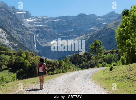 A woman hiker and cirque de Gavarnie in the French pyrenees Stock Photo