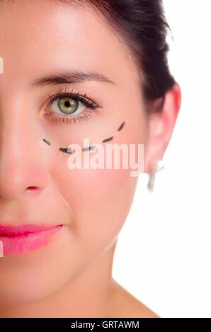 Closeup half of face caucasian woman with dotted lines drawn around left eye, preparing cosmetic surgery Stock Photo