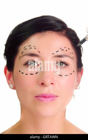 Headshot caucasian woman with dotted lines drawn around eyes looking into camera, preparing cosmetic surgery Stock Photo