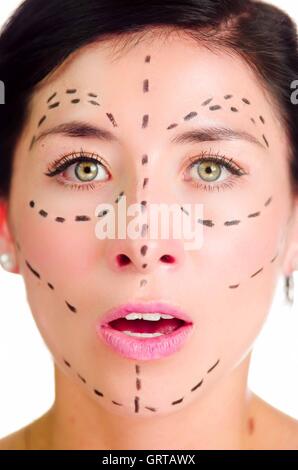 Closeup headshot caucasian woman with dotted lines drawn around face looking into camera, preparing cosmetic surgery Stock Photo