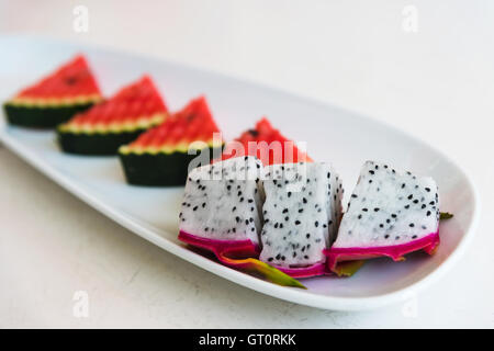 sliced dragon fruit and watermelon on plate Stock Photo