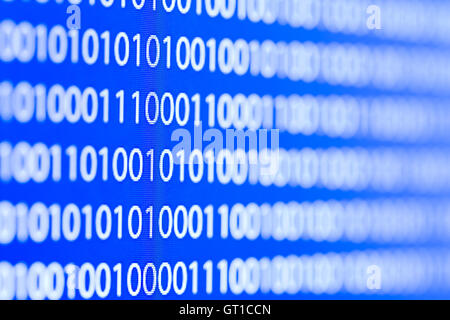 Binary code on a computer monitor blurred background Stock Photo