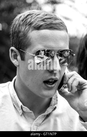 A Good Looking Young Man Using A Mobile Phone, Sussex, UK Stock Photo