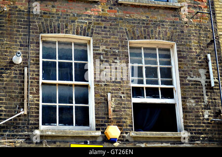 two typical British windows in a brick wall opened and closed, Uk, London Stock Photo