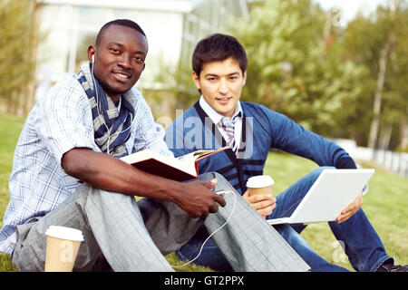Students Studying on Lawn Stock Photo