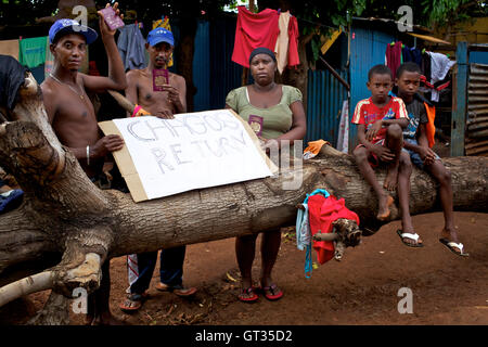 Chagos -  07/04/2012  -  Mauritius / Port-Louis  -  The family of Meri Elysee at home in the slum of Baie du Tombeau, Mauritius, with a chagossian flag, passports and a demonstration cartel for right to return   -  Olivier Goujon / Le Pictorium Stock Photo