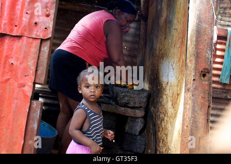 Chagos -  06/04/2012  -  Mauritius  -  Meri-Elysee and daughter in their kitchen, Baie du Tombeau slum, suburb of Port-Louis, Mauritius   -  Olivier Goujon / Le Pictorium Stock Photo