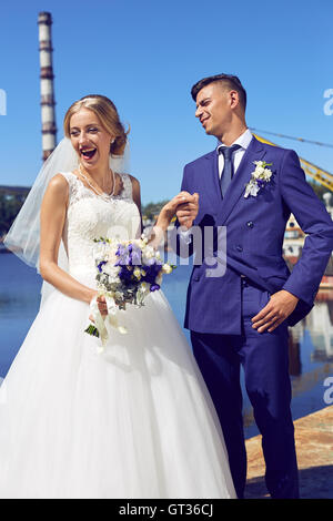 Bride and groom holding hands in the port Stock Photo