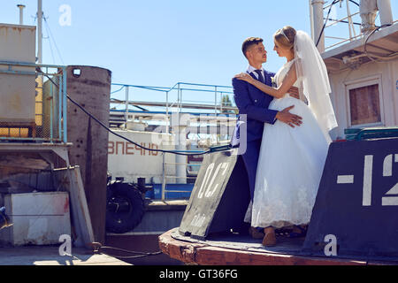 Beautiful young newlyweds on the wedding  the boat Stock Photo