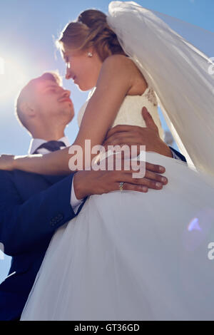 Closeup bride and groom are embracing at sunset Stock Photo