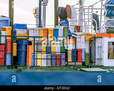 Fishing boat loaded with colorful fish boxes Stock Photo