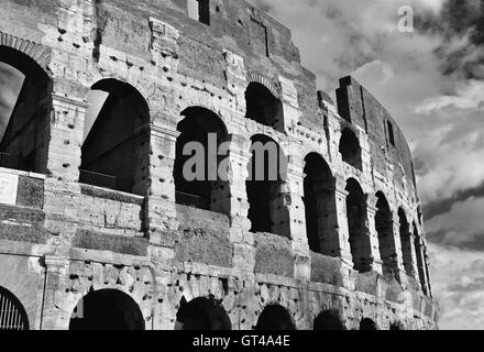 Monumental arches of Coliseum southern facade with cloudy sky Stock Photo