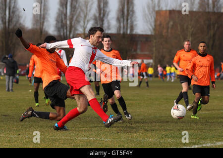 Gladstone Wanderers (white/red) vs Wojak Sunday - Hackney & Leyton Sunday League Jack Morgan Cup Football at South Marsh, Hackney Marshes, London - 22/02/15 Stock Photo